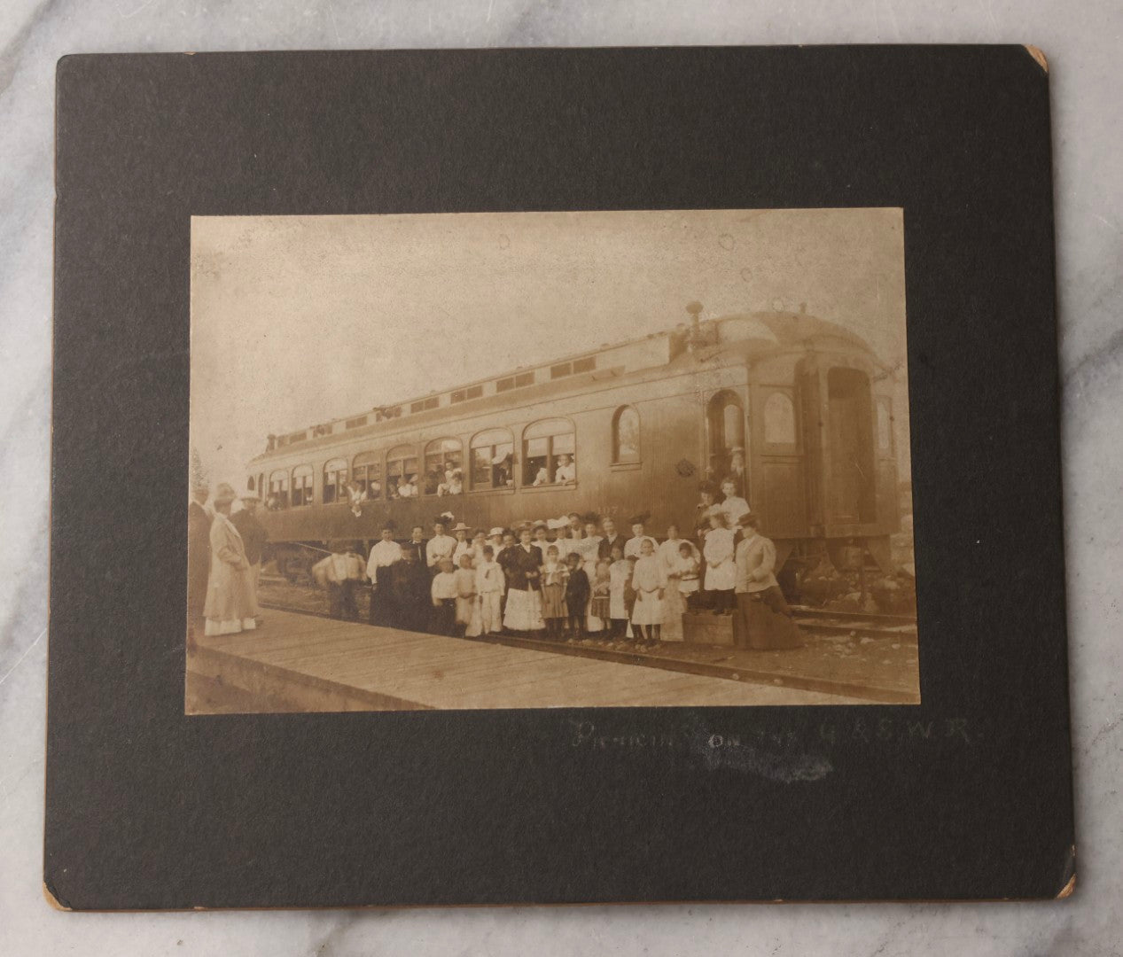 Lot 080 - Pair Of Antique Boarded Photographs Including Passengers Posing Beside Train Car With Handwritten Caption Referring To A Picnic, And Two Railroad Conductors Or Ticket Takers In Uniform
