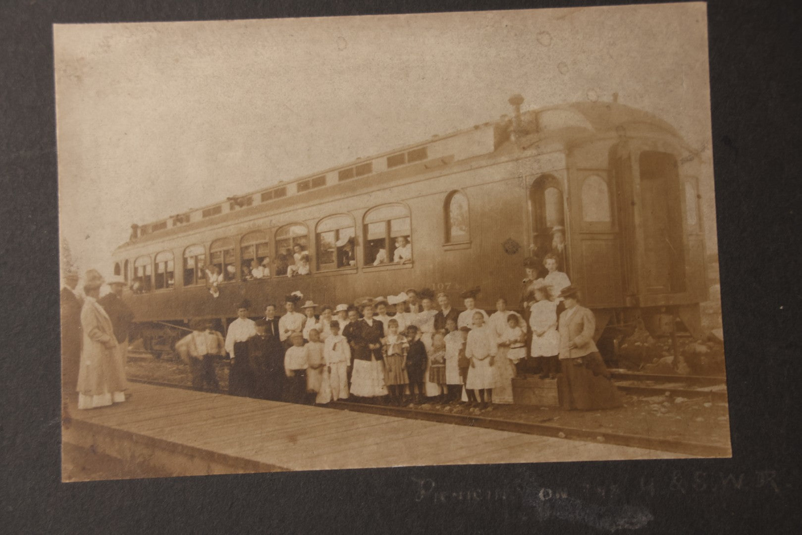 Lot 080 - Pair Of Antique Boarded Photographs Including Passengers Posing Beside Train Car With Handwritten Caption Referring To A Picnic, And Two Railroad Conductors Or Ticket Takers In Uniform
