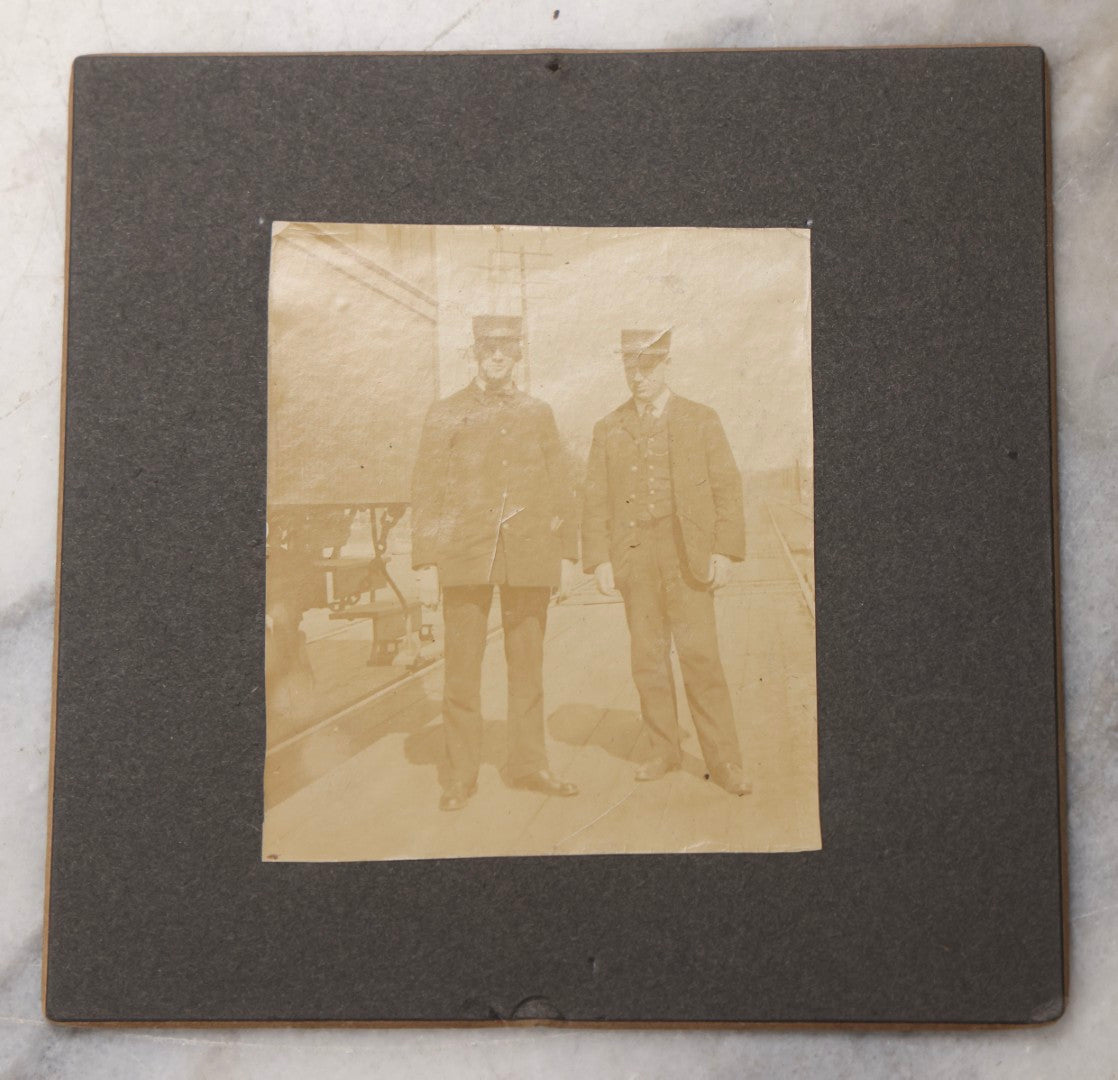 Lot 080 - Pair Of Antique Boarded Photographs Including Passengers Posing Beside Train Car With Handwritten Caption Referring To A Picnic, And Two Railroad Conductors Or Ticket Takers In Uniform