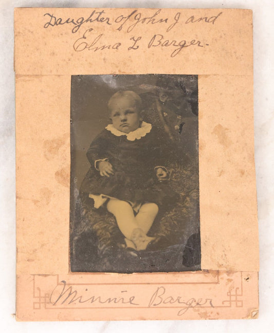 Lot 087 - Antique Tintype Photograph Of Baby In Mother's Lap, A “Not-So-Hidden Mother” Portrait, Identified As Minnie Barger, Daughter Of John J. And Elma L. Barger, In Makeshift Paper Frame