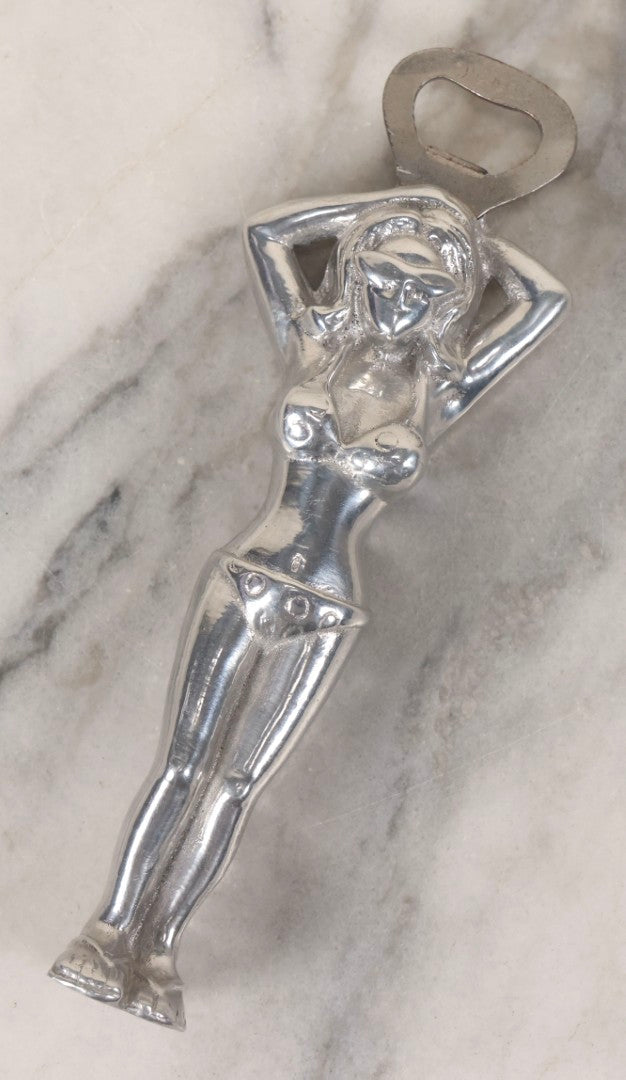 Lot 094 - Vintage Cast Aluminum Bikini Babe Bottle Opener, Woman With Sunglasses And Polka Dot Bikini, Circa 1980s 7-3/4" L