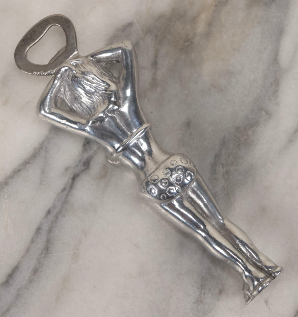 Lot 094 - Vintage Cast Aluminum Bikini Babe Bottle Opener, Woman With Sunglasses And Polka Dot Bikini, Circa 1980s 7-3/4" L