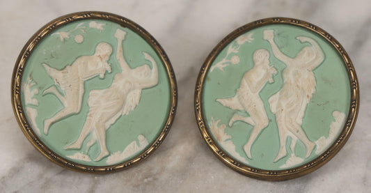 Lot 127 - Pair Of Antique Brass-Mounted Jasperware-Style Hatpins Or Brooches With Dancing Classical Figures, Woman With Cup And Man Playing Flute
