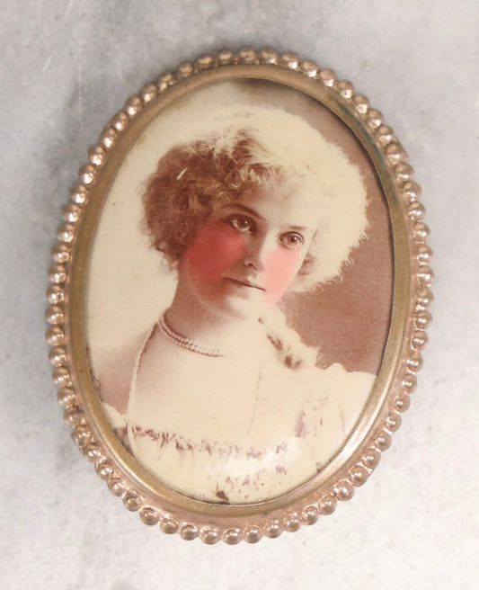 Lot 133 - Antique Celluloid Portrait Brooch With Hand-Tinted Photograph Of Young Woman With Rosy Cheeks In Brass Bezel