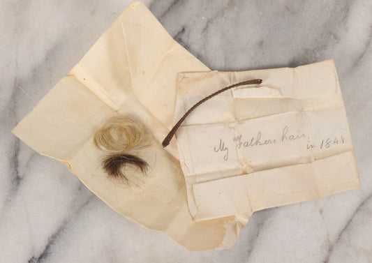 Lot 137 - Antique Hair Relics Including Braid With Inscribed Paper Label “My Father's Hair, In 1848… Oct 23rd 1880” And Folded Paper Containing Two Curls Of Hair