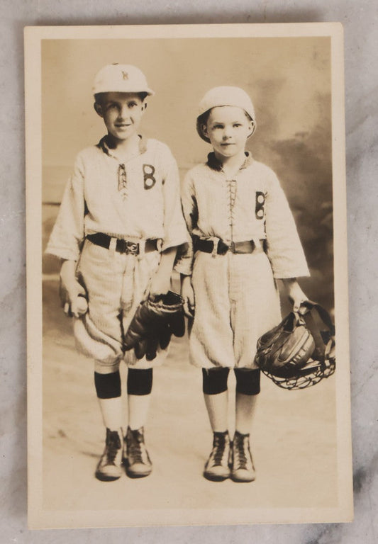 Lot 162 - Antique Real Photo Postcard R.P.P.C.. Of Two Young Boys In Baseball Uniforms With Glove, Ball, And Catcher's Mask, Undivided Back