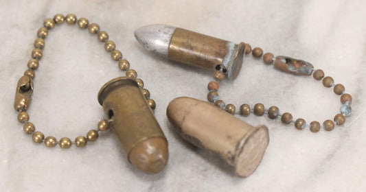 Lot 189 - Trio Of Vintage Bullet Novelties Including Two Bullet Keychains And “Lone Ranger” Toy Bullet