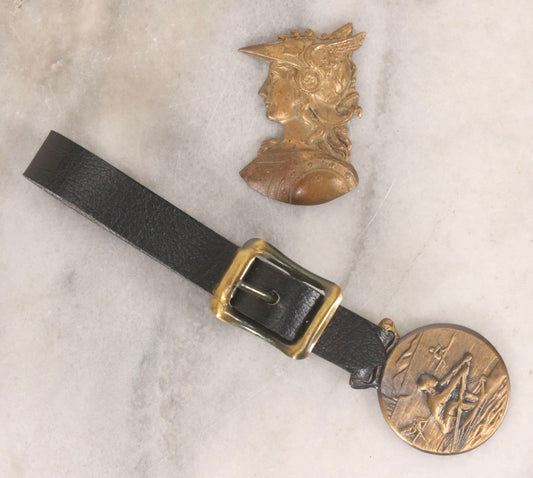 Lot 191 - Pair Of Vintage Pressed Metal Items Including Hermes Brass Ornament And Rowing Watch Fob With River Scene