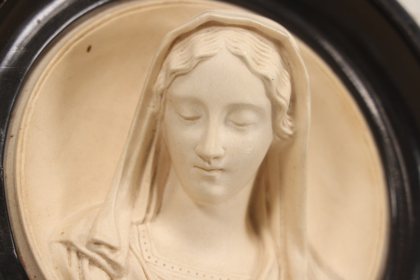 Lot 006 - Antique Carved Meerschaum Plaque Of The Virgin Mary In Black Lacquered Wood Frame, Likely French, Early 20th Century, 10" Diameter