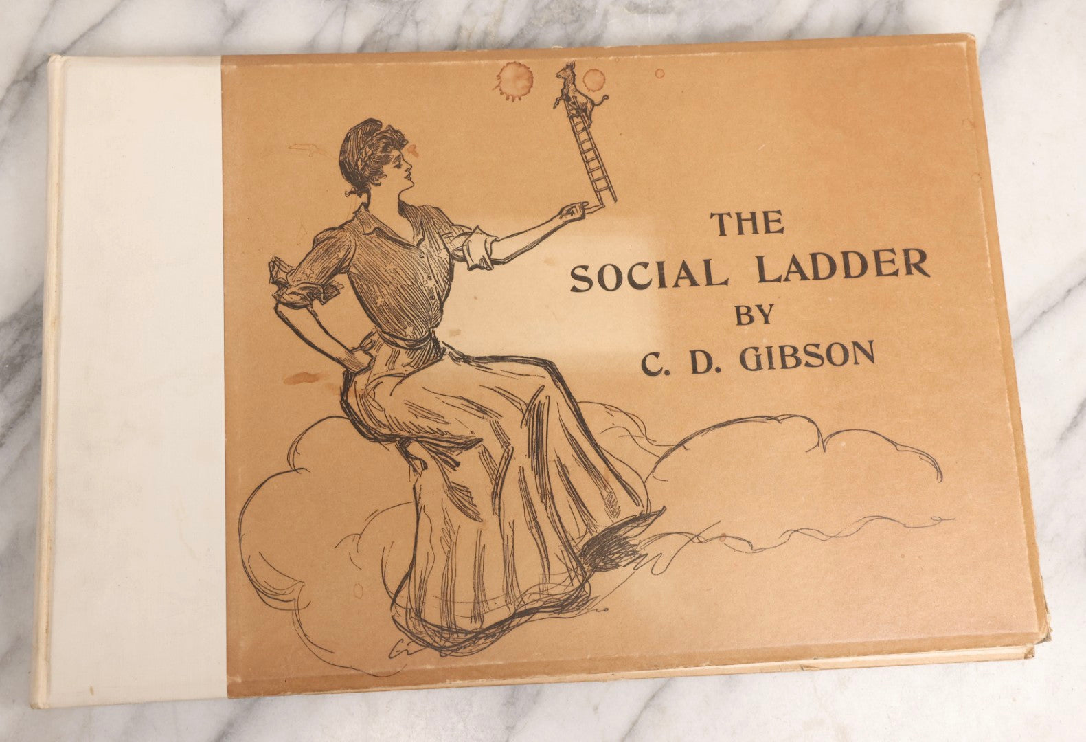 Lot 032 - “The Social Ladder” Antique Illustrated Book By Charles Dana Gibson, Published By R.H. Russell, New York, And John Lane, London, 1902, With Partial Original Presentation Sleeve