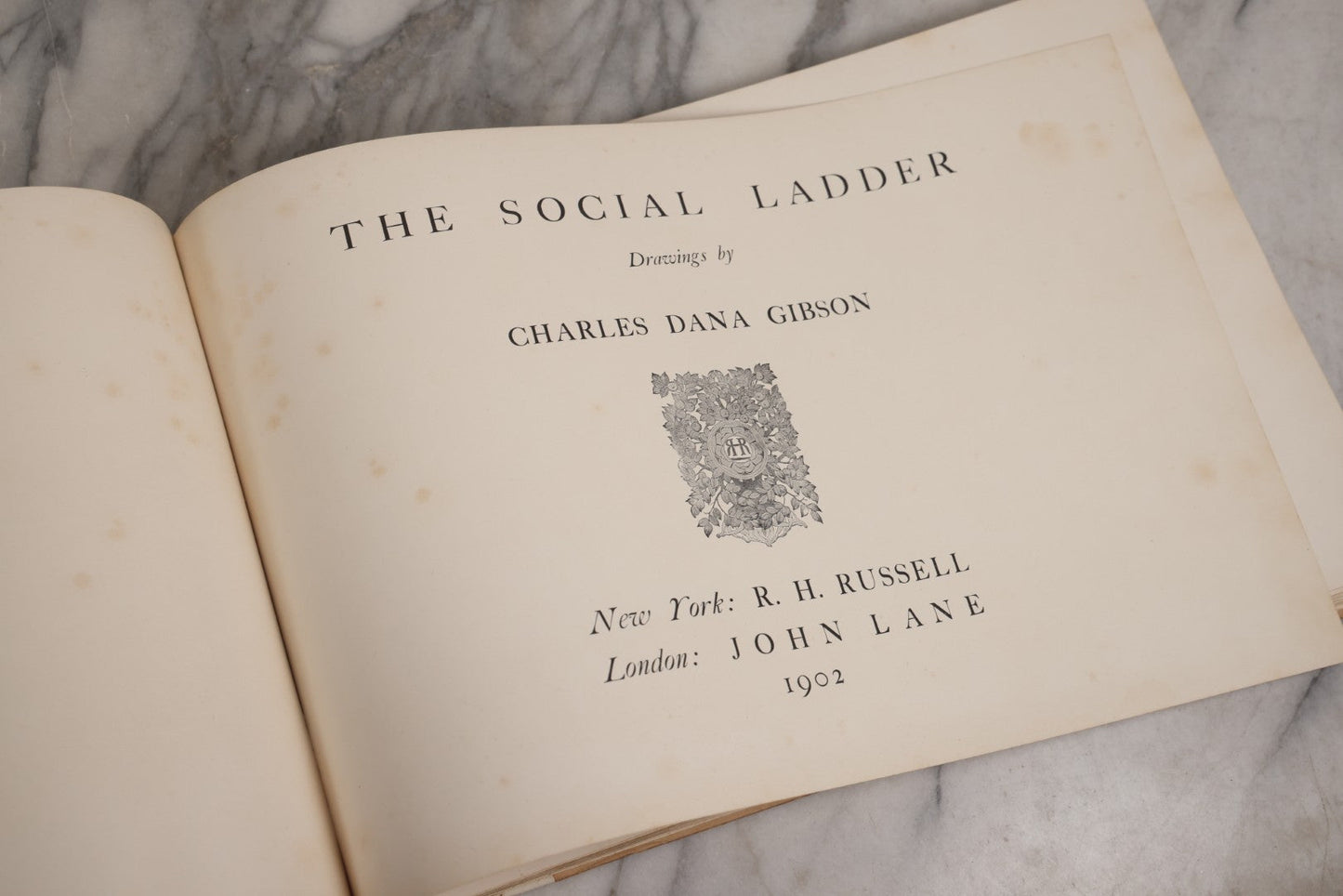 Lot 032 - “The Social Ladder” Antique Illustrated Book By Charles Dana Gibson, Published By R.H. Russell, New York, And John Lane, London, 1902, With Partial Original Presentation Sleeve