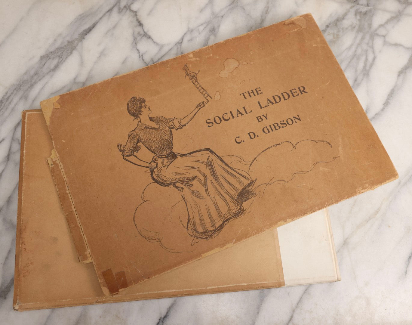 Lot 032 - “The Social Ladder” Antique Illustrated Book By Charles Dana Gibson, Published By R.H. Russell, New York, And John Lane, London, 1902, With Partial Original Presentation Sleeve