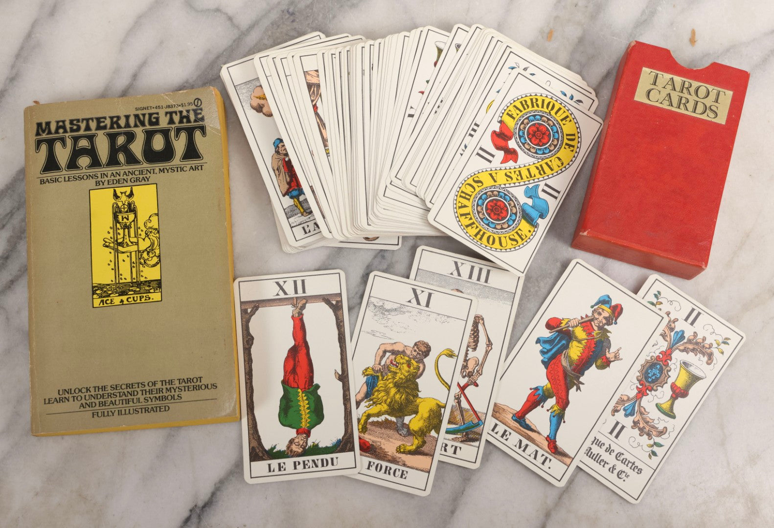 Lot 034 - Pair Of Vintage Tarot Items Including J. Muller & Cie French Marseille-Style Tarot Deck Of 78 Cards With Red Slip Case And "Mastering The Tarot" Paperback Book By Eden Gray, 1973
