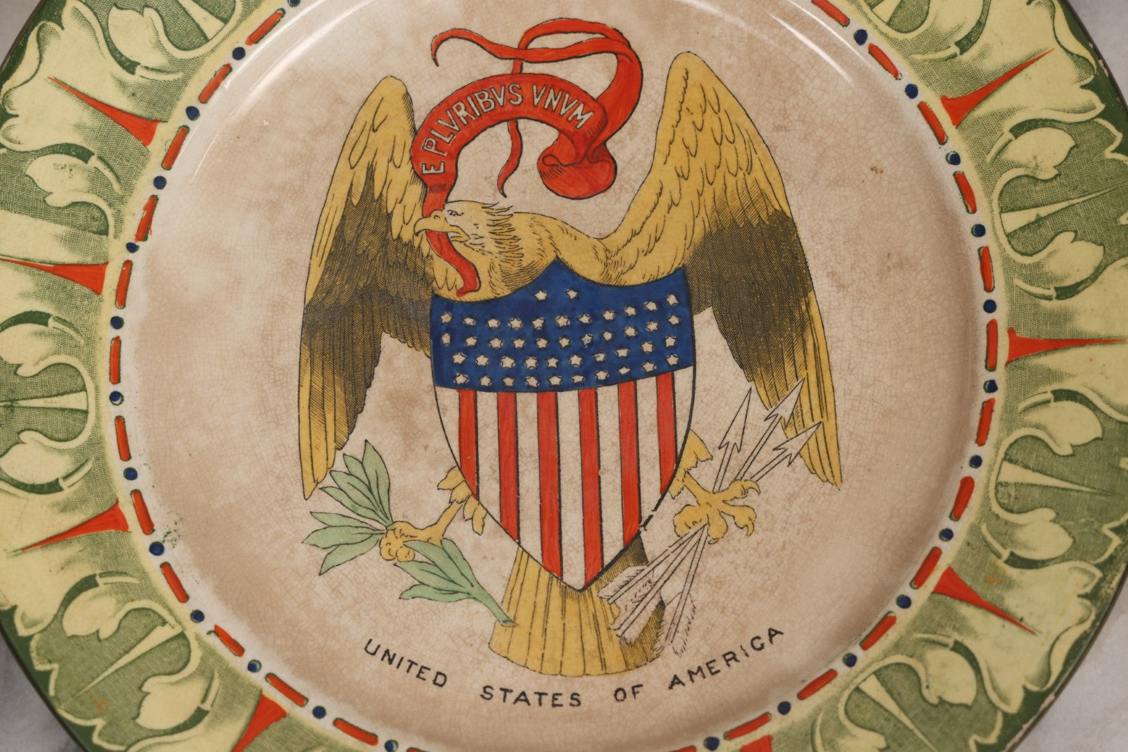 Lot 043 - Antique Hand Colored Transferware Pottery Patriotic Plate By Frank Beardmore & Co., Fenton, "National Emblems" Line With Bald Eagle, Patriotic Shield, And "E Pluribus Unum" Banner, 10" Diameter
