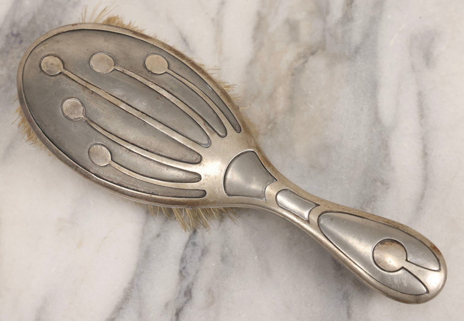 Lot 053 - Antique Art Deco Metal Clad Dresser Brush With Stylized Radiating Oval Motif, 9" L