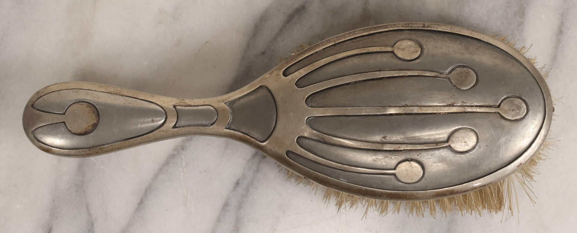 Lot 053 - Antique Art Deco Metal Clad Dresser Brush With Stylized Radiating Oval Motif, 9" L