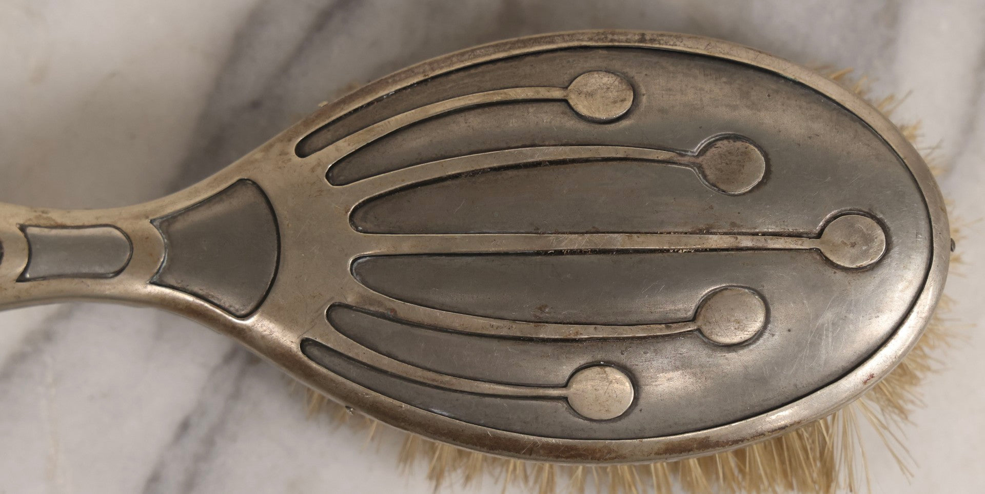 Lot 053 - Antique Art Deco Metal Clad Dresser Brush With Stylized Radiating Oval Motif, 9" L