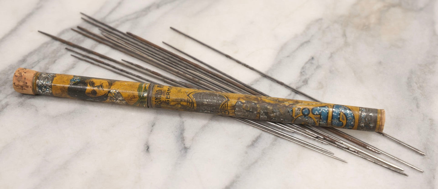 Lot 054 - Antique Gloria Brand Highly Tempered Steel Knitting Pins In Original Tin Lithograph Tube With Woman's Face Motif, Made In Germany, 9-3/4" L