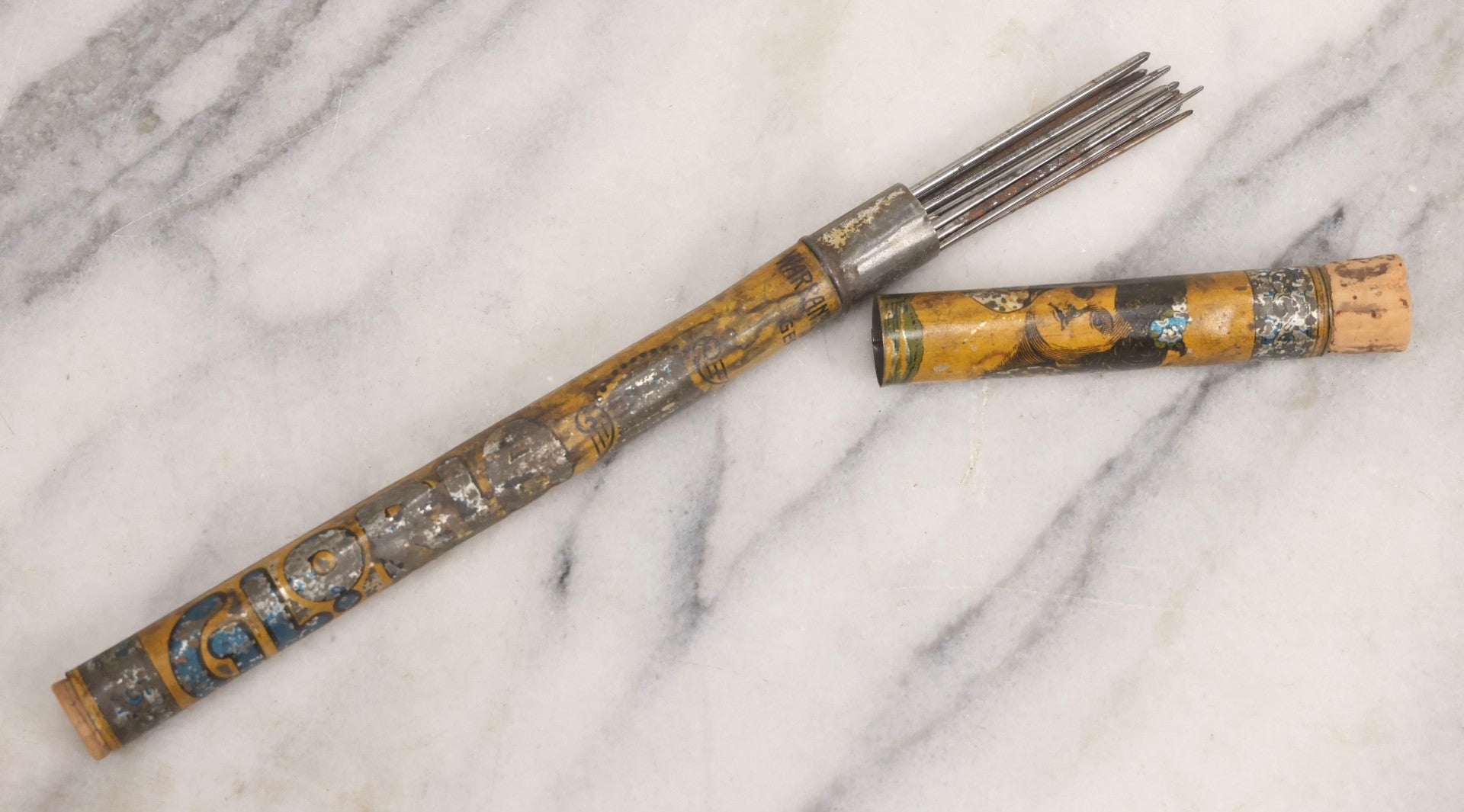 Lot 054 - Antique Gloria Brand Highly Tempered Steel Knitting Pins In Original Tin Lithograph Tube With Woman's Face Motif, Made In Germany, 9-3/4" L