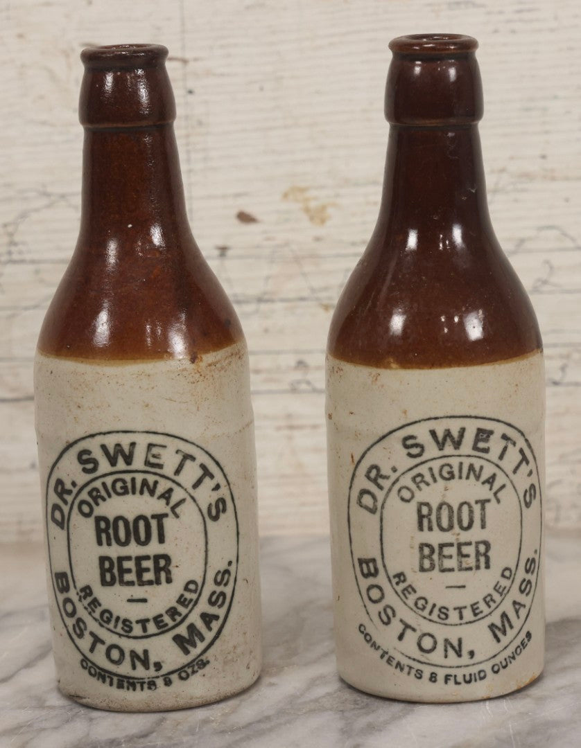 Lot 059 - Pair Of Antique Stoneware Soda Bottles For Dr. Swett's Original Root Beer, Boston, Massachusetts, 8 Fluid Ounces, 7-3/4" H Each