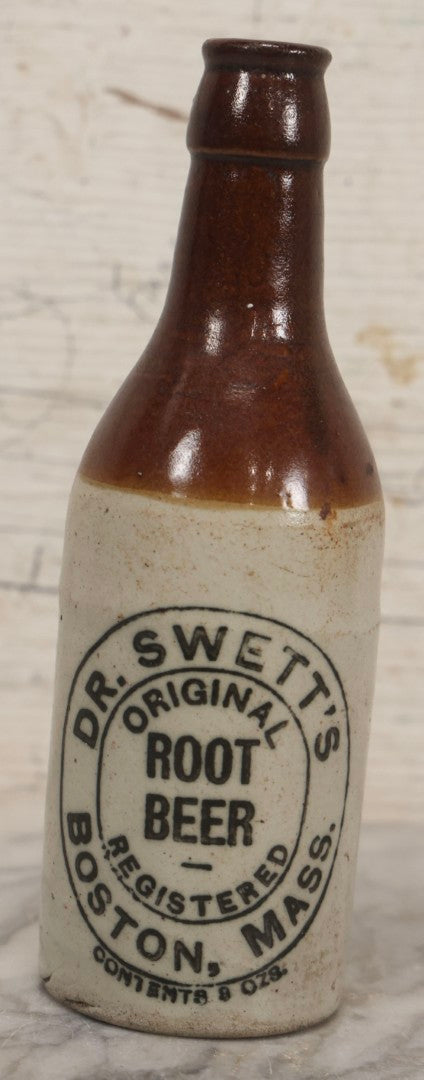 Lot 059 - Pair Of Antique Stoneware Soda Bottles For Dr. Swett's Original Root Beer, Boston, Massachusetts, 8 Fluid Ounces, 7-3/4" H Each