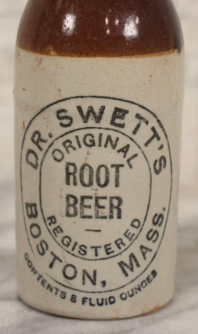 Lot 059 - Pair Of Antique Stoneware Soda Bottles For Dr. Swett's Original Root Beer, Boston, Massachusetts, 8 Fluid Ounces, 7-3/4" H Each