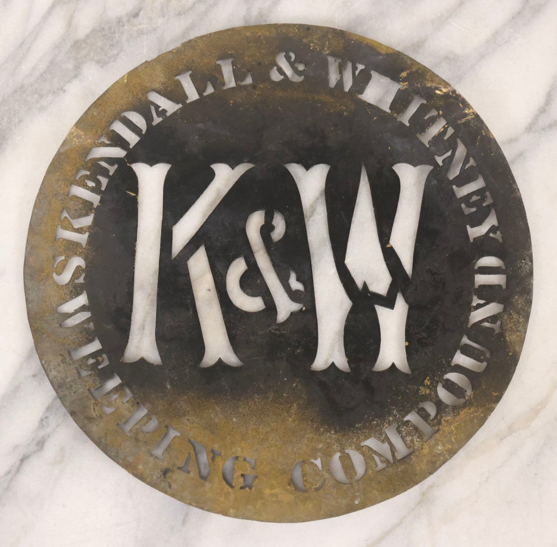 Lot 061 - Antique Die Cut Stamped Brass Advertising Stencil For Kendall & Whitney Sweeping Compound With Large “K & W” Monogram, 10" Diameter