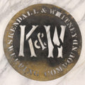 Lot 061 - Antique Die Cut Stamped Brass Advertising Stencil For Kendall & Whitney Sweeping Compound With Large “K & W” Monogram, 10" Diameter