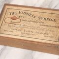Lot 062 - Antique Wooden Slide-Top Box For The Empress Syringe No. 1 By Whitall Tatum Company With Paper Label, Stamped Germany