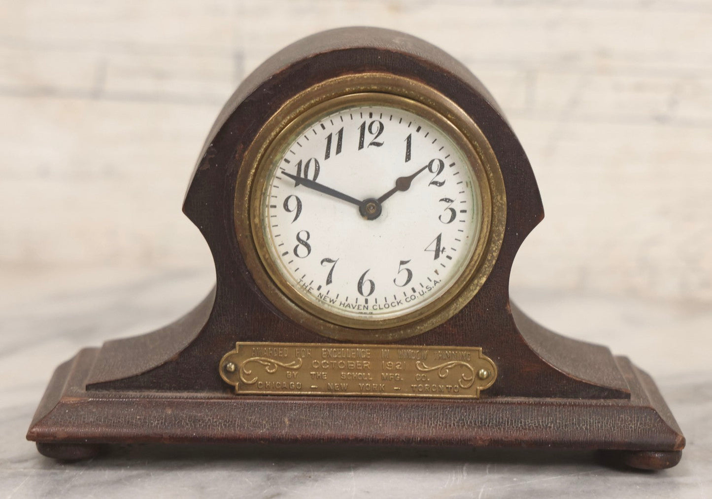 Lot 069 - Antique New Haven Clock Co. Tambour Mantel Clock Awarded For Excellence In Window Trimming, October 1921, The Scholl Mfg. Co., Untested, 3-1/2" H