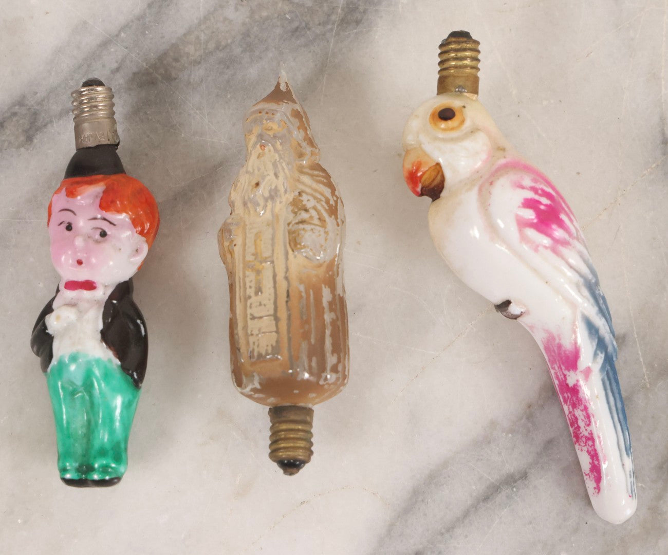 Lot 071 - Trio Of Antique Hand Painted Figural Candelabra Light Bulbs Including Santa Claus, Little Boy, And Parrot, 3-1/2" To 4-1/4" L