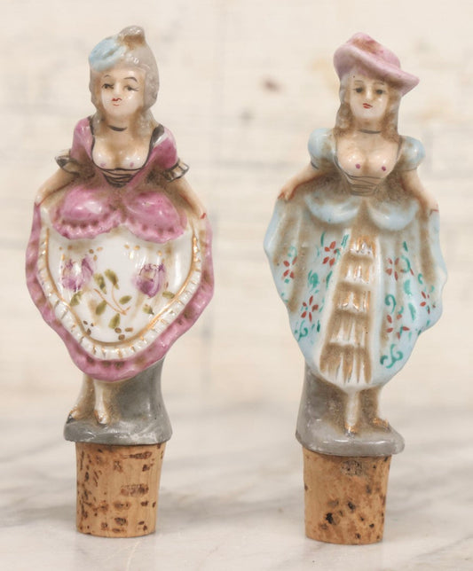 Lot 073 - Pair Of Vintage Porcelain Risqué Cork Bottle Topper Liquor Pourers With Victorian Women Showing Off Their Behinds, 5" H Each
