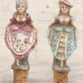 Lot 073 - Pair Of Vintage Porcelain Risqué Cork Bottle Topper Liquor Pourers With Victorian Women Showing Off Their Behinds, 5" H Each