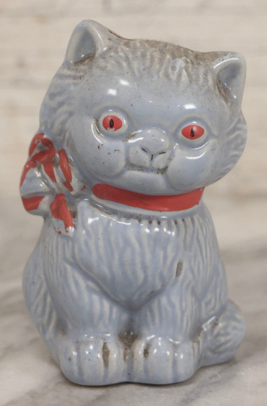 Lot 075 - Vintage Porcelain Hubley-Style Cat Still Bank With Blue Body, Red Eyes, And Red Bow, Note Damage, 4-1/2" H
