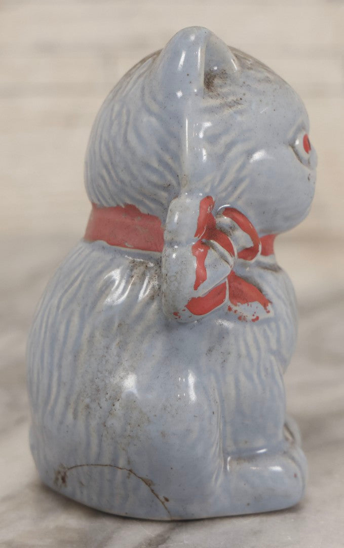 Lot 075 - Vintage Porcelain Hubley-Style Cat Still Bank With Blue Body, Red Eyes, And Red Bow, Note Damage, 4-1/2" H