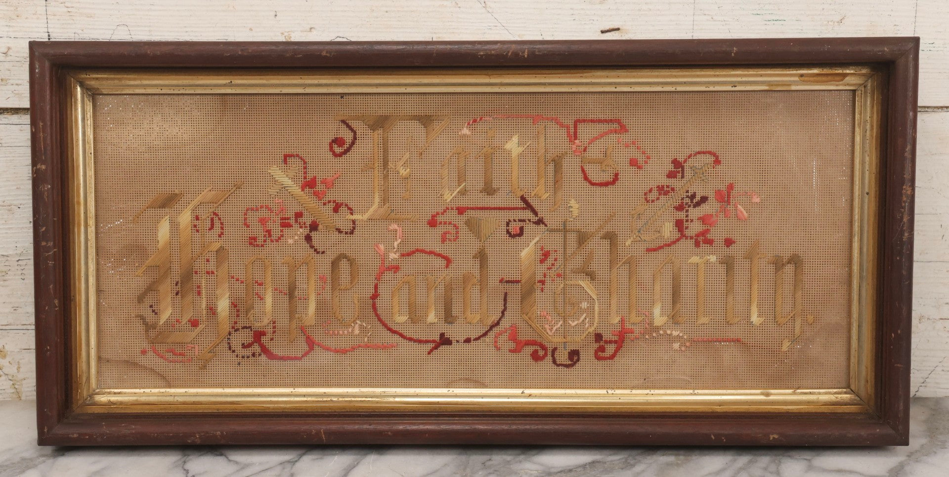 Lot 097 - Antique Victorian Punchwork Embroidery Motto “Faith, Hope, And Charity” In Deep Walnut Frame With Gold Inner Border, 23-1/4" x 10-3/4"