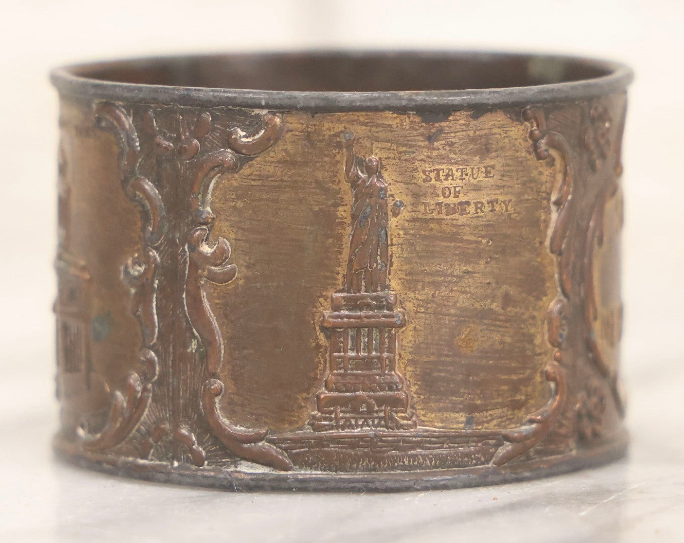 Lot 118 - Antique Pot Metal Souvenir Napkin Ring Featuring New York City Landmarks Including Statue Of Liberty, Grant's Tomb And Flatiron Building