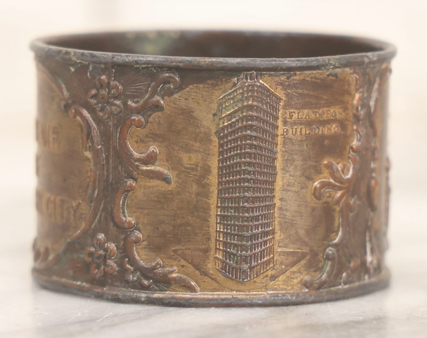 Lot 118 - Antique Pot Metal Souvenir Napkin Ring Featuring New York City Landmarks Including Statue Of Liberty, Grant's Tomb And Flatiron Building