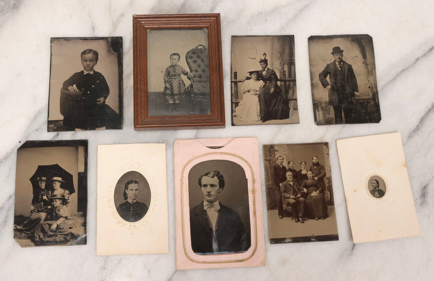 Lot 135 - Grouping Of Nine Antique Tintype Photographs Including Ladies With Parasol, Man In Bowler Hat, Group Portrait, And Child In Miniature Wood Frame