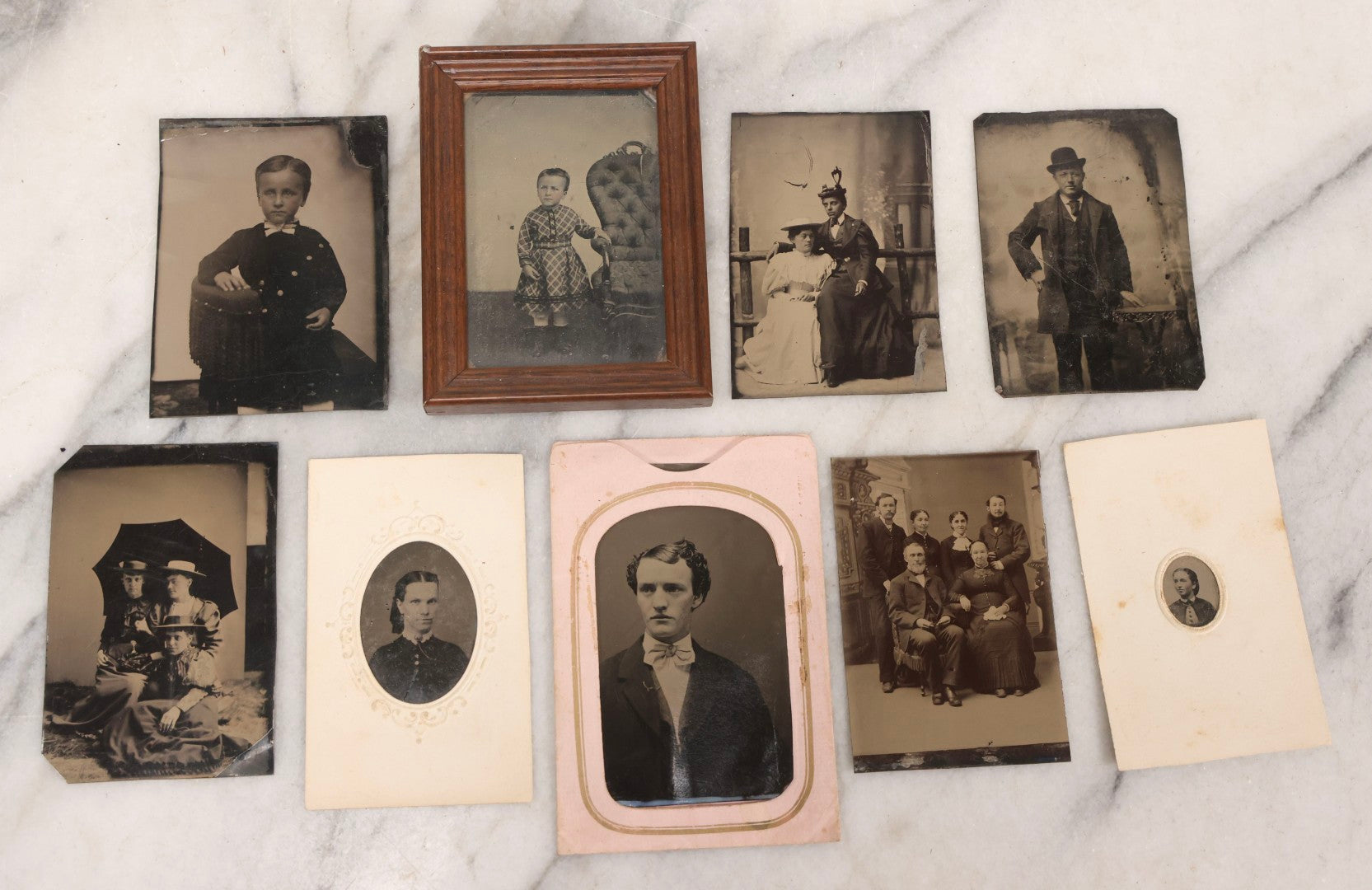 Lot 135 - Grouping Of Nine Antique Tintype Photographs Including Ladies With Parasol, Man In Bowler Hat, Group Portrait, And Child In Miniature Wood Frame