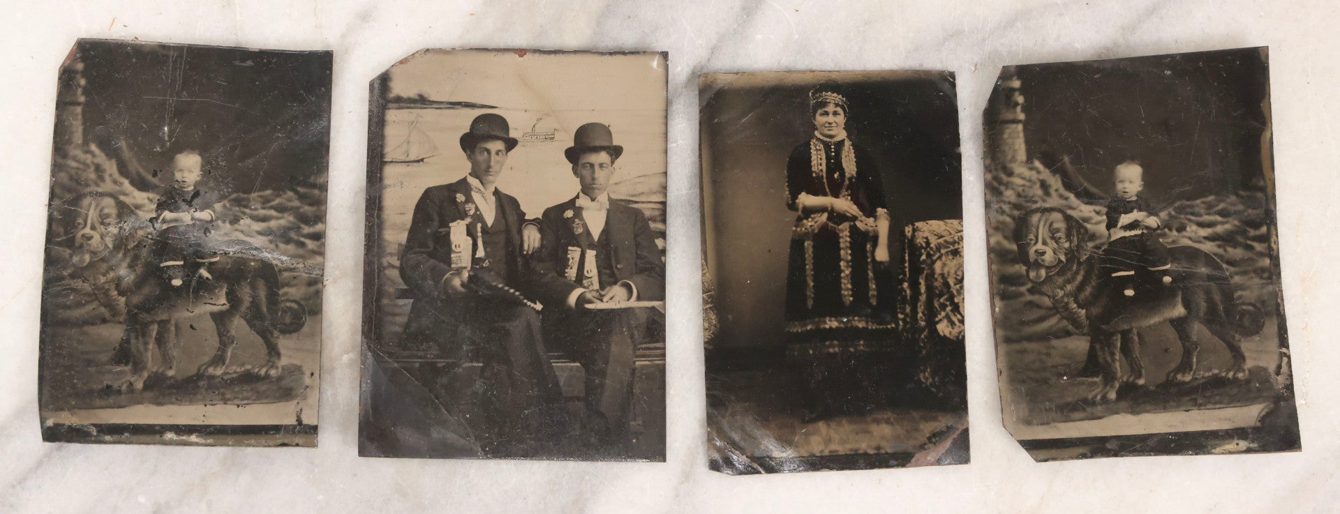 Lot 136 - Grouping Of Four Antique Tintype Photographs Including Two Humorous Baby Portraits Riding Dog Painted On Backdrop, Woman In Extravagant Dress, And Two Men Wearing Bowler Hats And Fraternal Ribbons