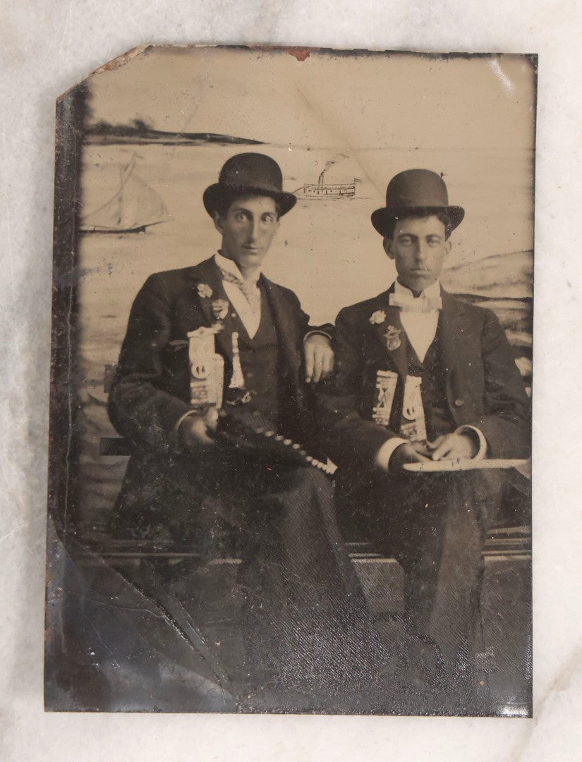 Lot 136 - Grouping Of Four Antique Tintype Photographs Including Two Humorous Baby Portraits Riding Dog Painted On Backdrop, Woman In Extravagant Dress, And Two Men Wearing Bowler Hats And Fraternal Ribbons