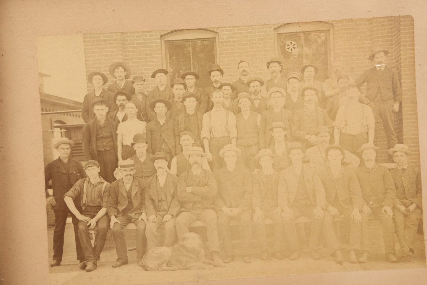Lot 137 - Antique Occupational Boarded Photograph Of Factory Workers With Dog In Deep Walnut Frame, Circa 1880–1890, 13-1/2" x 11-1/2"