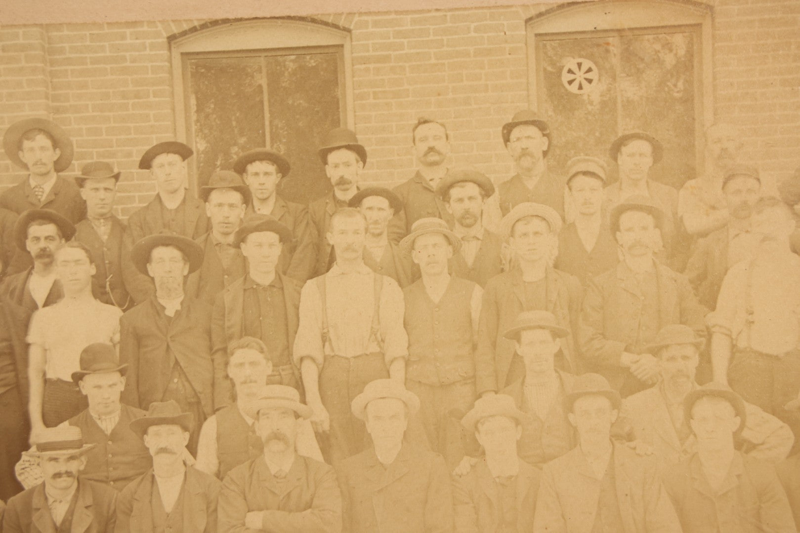 Lot 137 - Antique Occupational Boarded Photograph Of Factory Workers With Dog In Deep Walnut Frame, Circa 1880–1890, 13-1/2" x 11-1/2"
