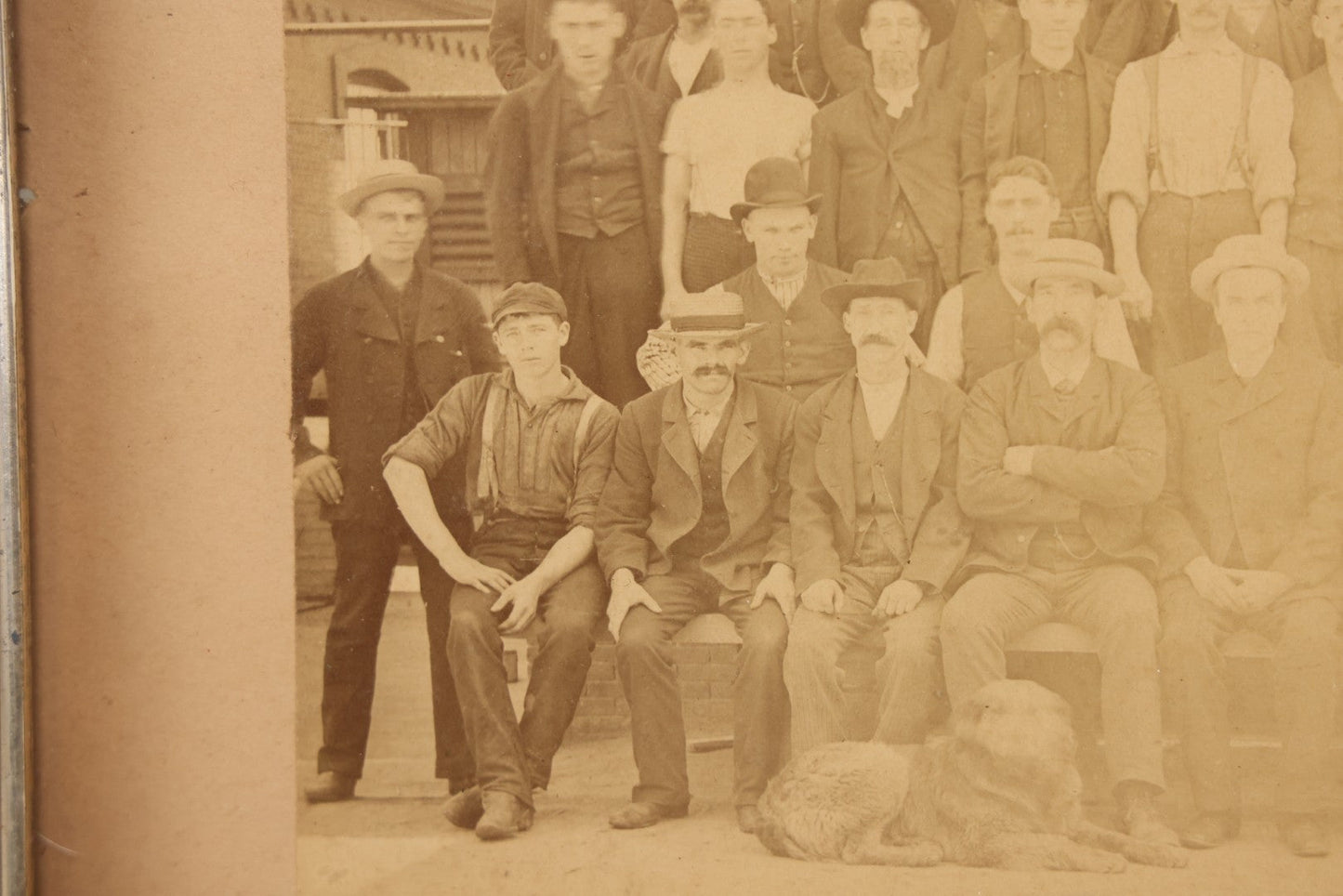Lot 137 - Antique Occupational Boarded Photograph Of Factory Workers With Dog In Deep Walnut Frame, Circa 1880–1890, 13-1/2" x 11-1/2"