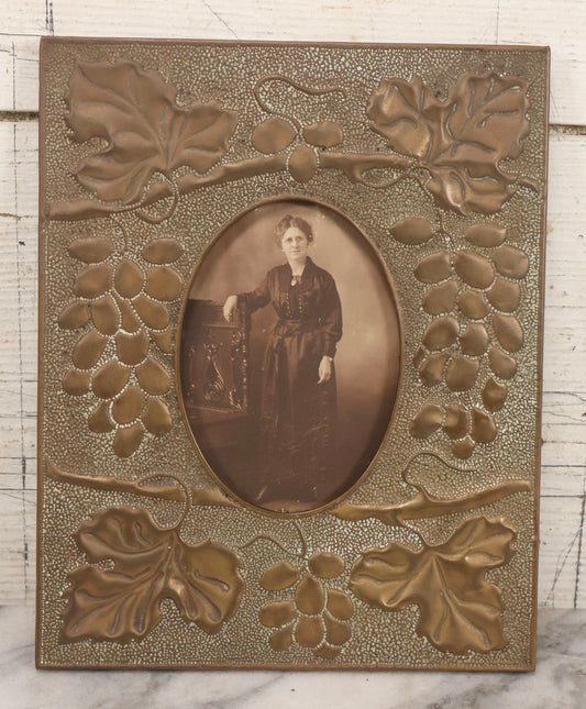 Lot 138 - Antique Hammered Brass Photo Frame With Grapes And Grape Leaves Motif, Missing Stand, 8-1/8" x 10"