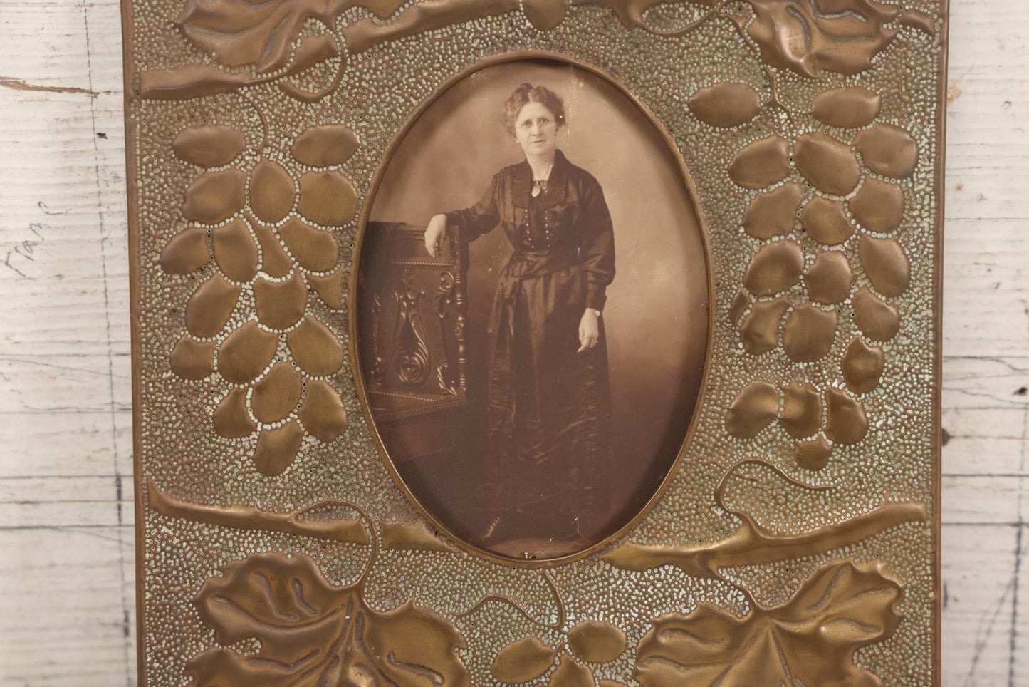 Lot 138 - Antique Hammered Brass Photo Frame With Grapes And Grape Leaves Motif, Missing Stand, 8-1/8" x 10"