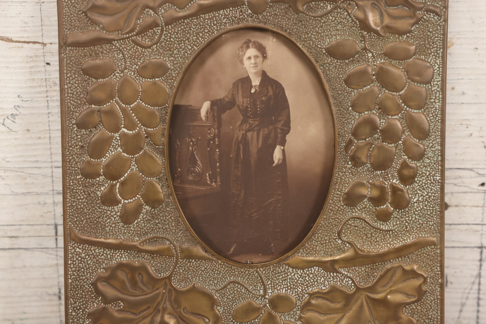 Lot 138 - Antique Hammered Brass Photo Frame With Grapes And Grape Leaves Motif, Missing Stand, 8-1/8" x 10"