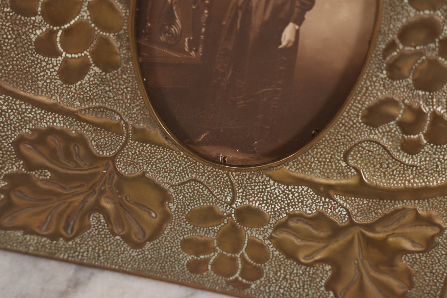Lot 138 - Antique Hammered Brass Photo Frame With Grapes And Grape Leaves Motif, Missing Stand, 8-1/8" x 10"