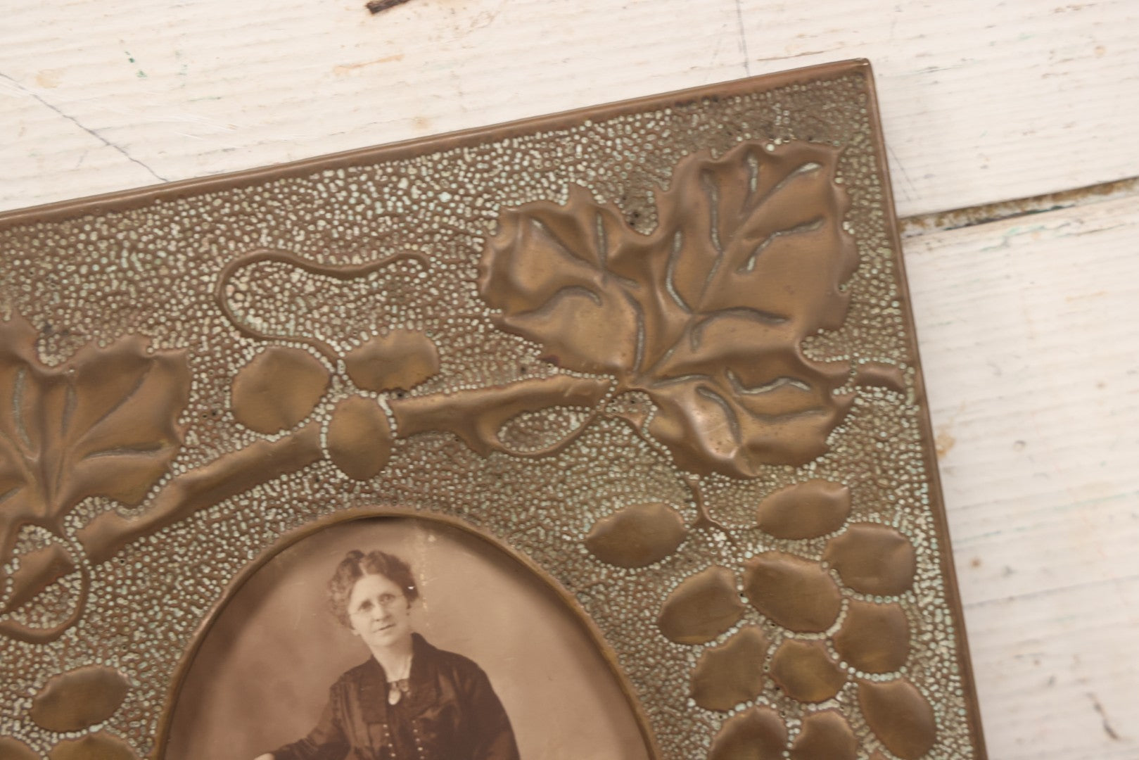 Lot 138 - Antique Hammered Brass Photo Frame With Grapes And Grape Leaves Motif, Missing Stand, 8-1/8" x 10"